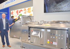 Luc van Buynder van Urschel staat bij de Translices 2520. De machines is zo geconstrueerd dat er geen platte onderdelen zijn maar alles schuin afloopt. Hierdoor blijft er geen water achter en is de machine erg hygienisch. Met de V-band machine kan sla en langwerpige producten worden gesneden.